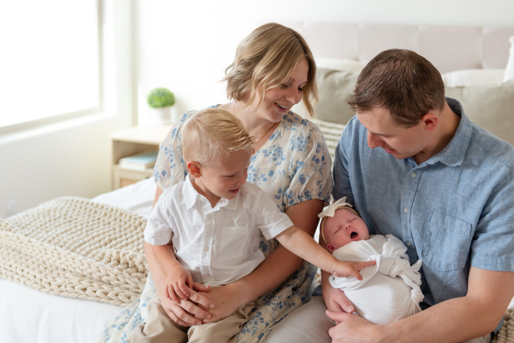 Family adoring newborn during in-home photos in St. George, Utah