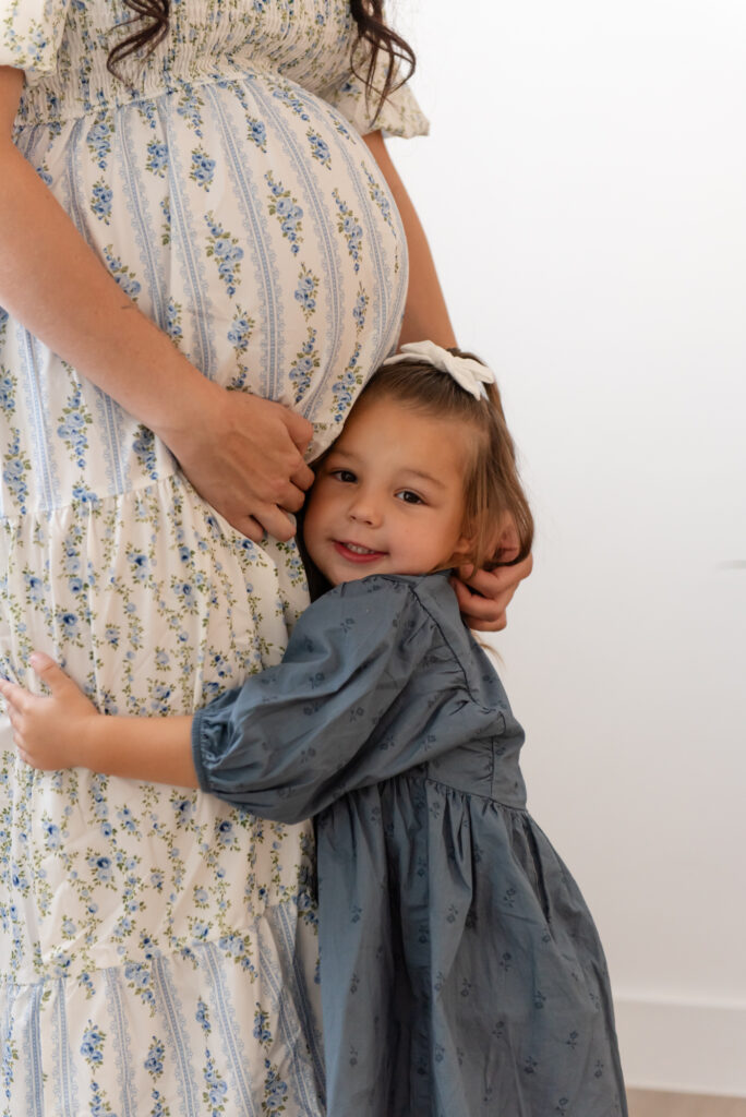 Southern Utah maternity photographer – candid family photos with toddler girl and baby bump