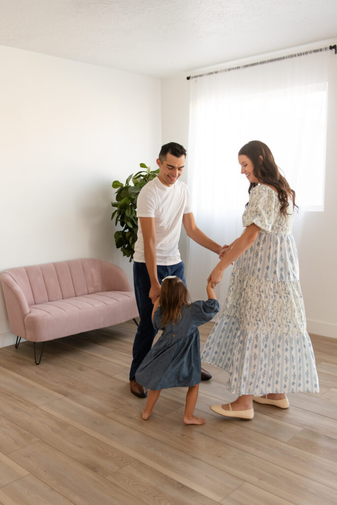 Hurricane Utah maternity session – dad, mom, and daughter playing Ring Around the Rosie