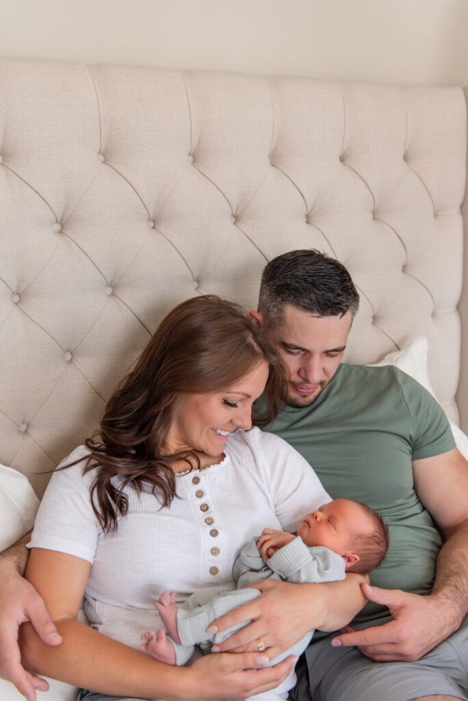 parents adoring newborn baby