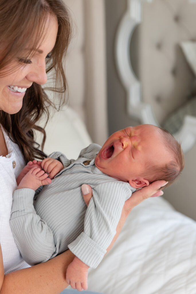 Mom adoring newborn baby yawning in st. George, Utah