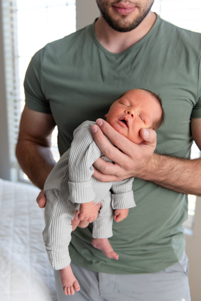 Baby sleeping in dads arms St. George, Utah Newborn