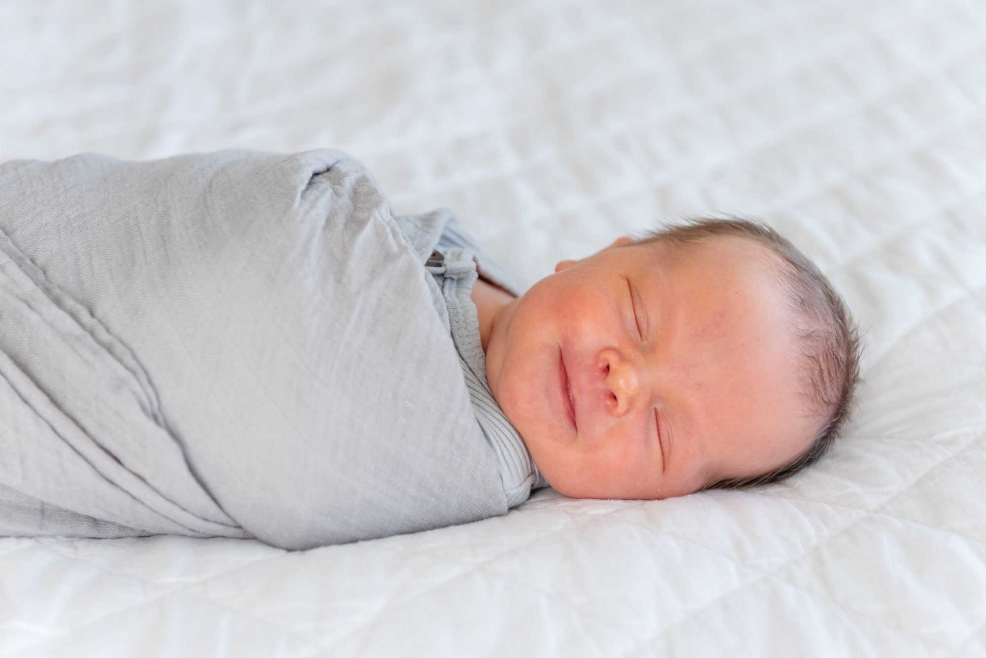 Sweet smile from newborn baby in St. George In-home session