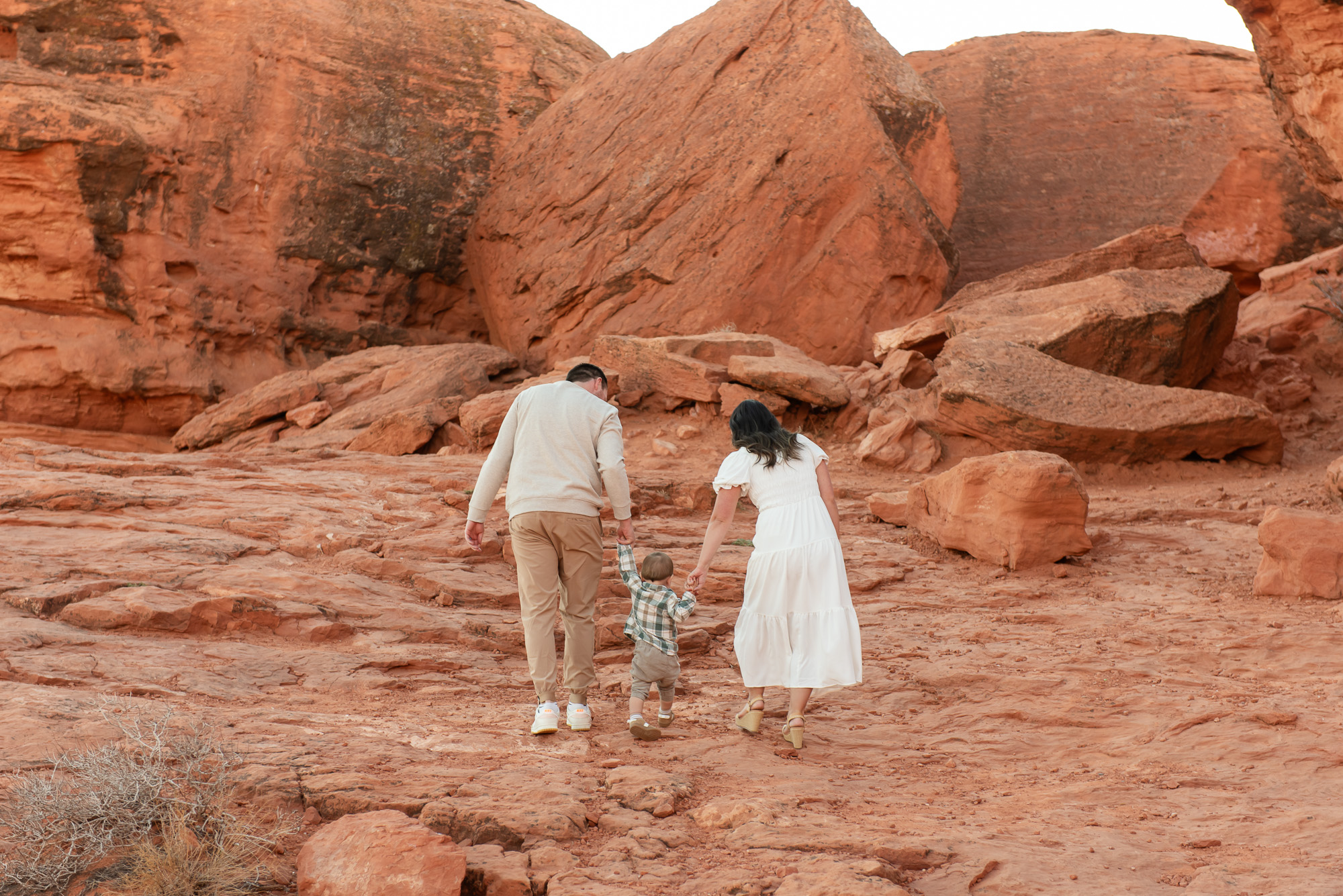 Toddler family exploring red rocks