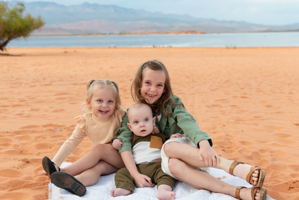 Siblings pose for photo on beach