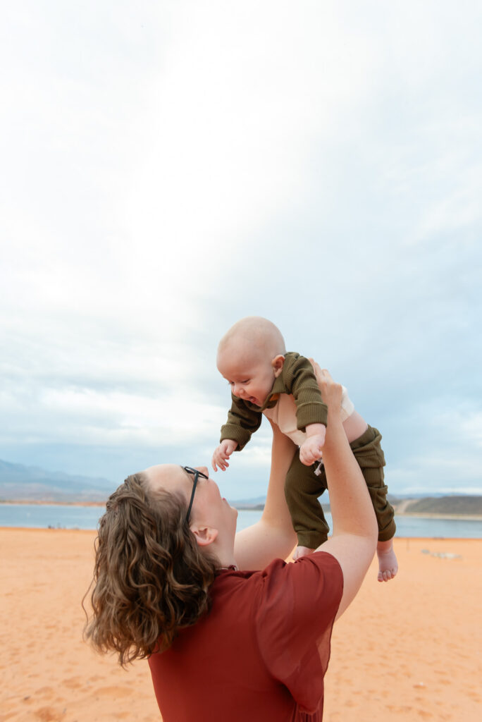 Mom holding baby up family photos St. George