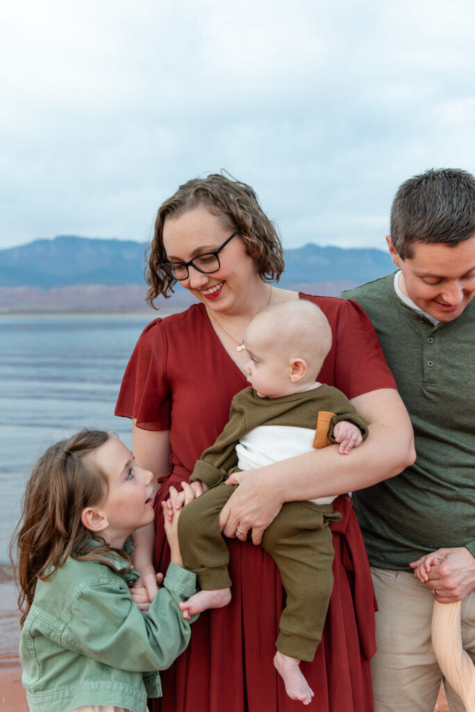 Sister adores brother during family photos