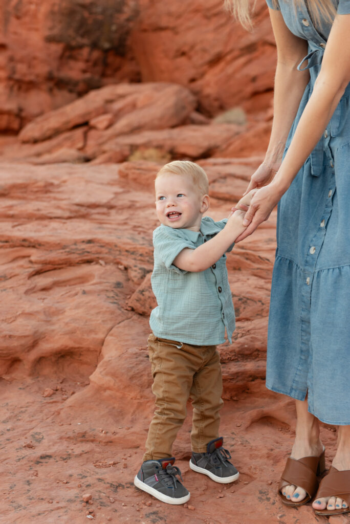 Toddler holding moms hands Pioneer Park St George Utah